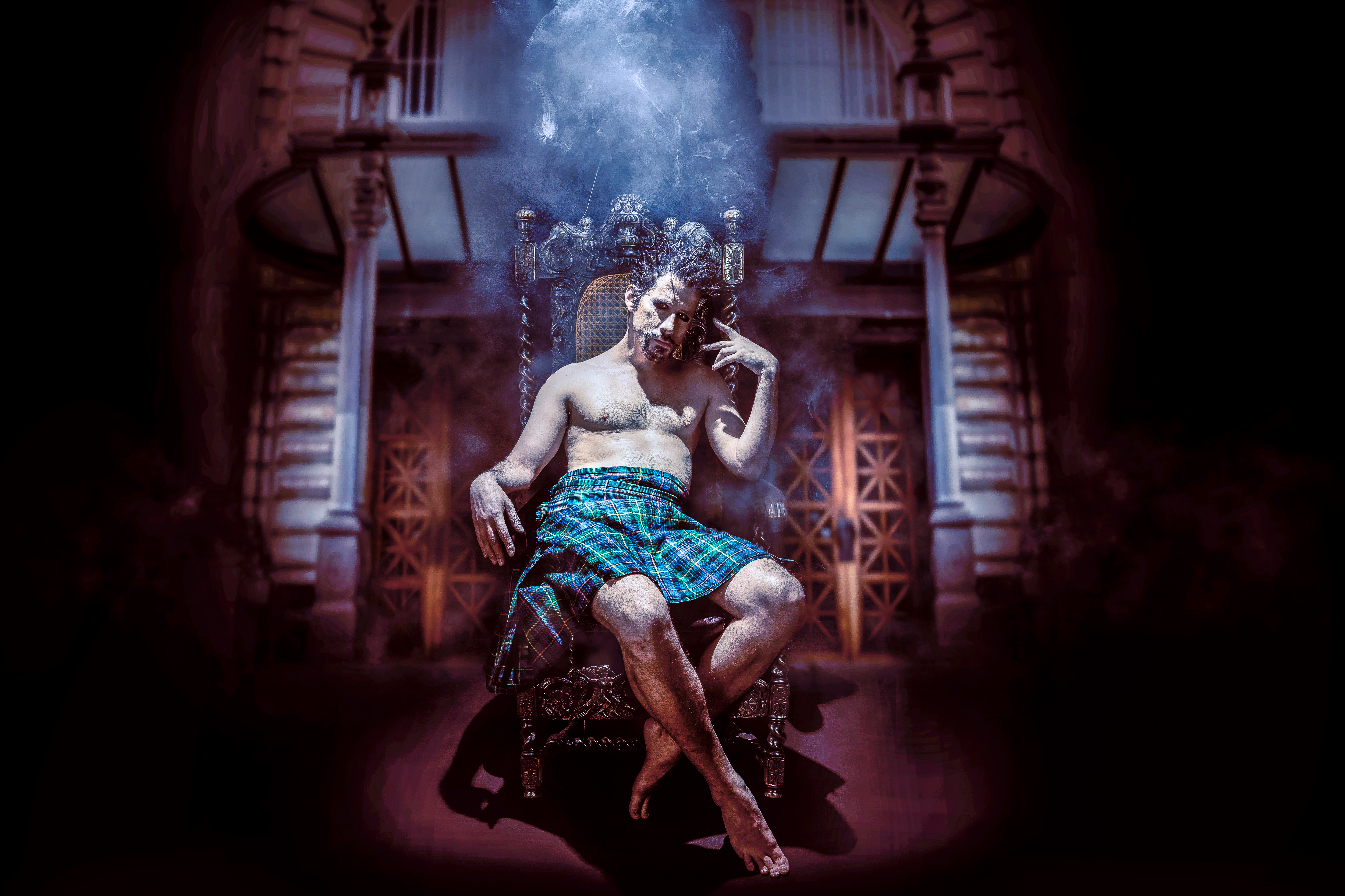 A figure seated on an ornate throne wearing a tartan kilt, surrounded by smoke and dramatic lighting in a Gothic interior — conceptual portrait by Pavel Tamm